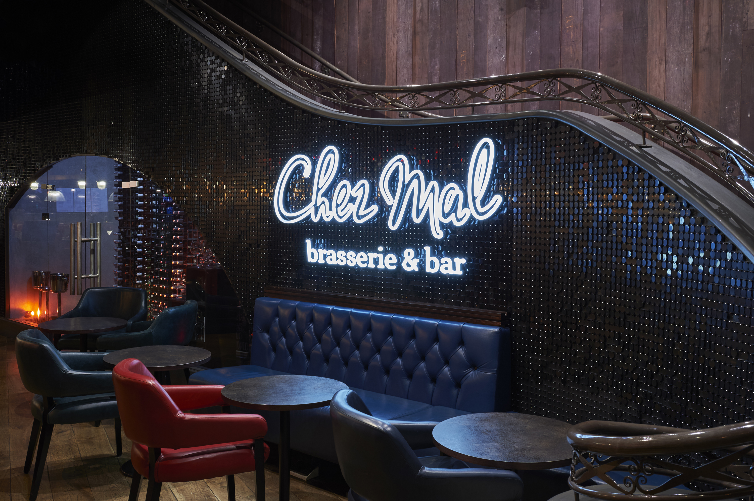 Chez Mal Logo on wall behind multiple tables and chairs