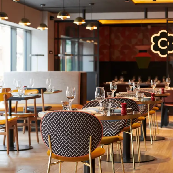 A restaurant featuring numerous tables and chairs.