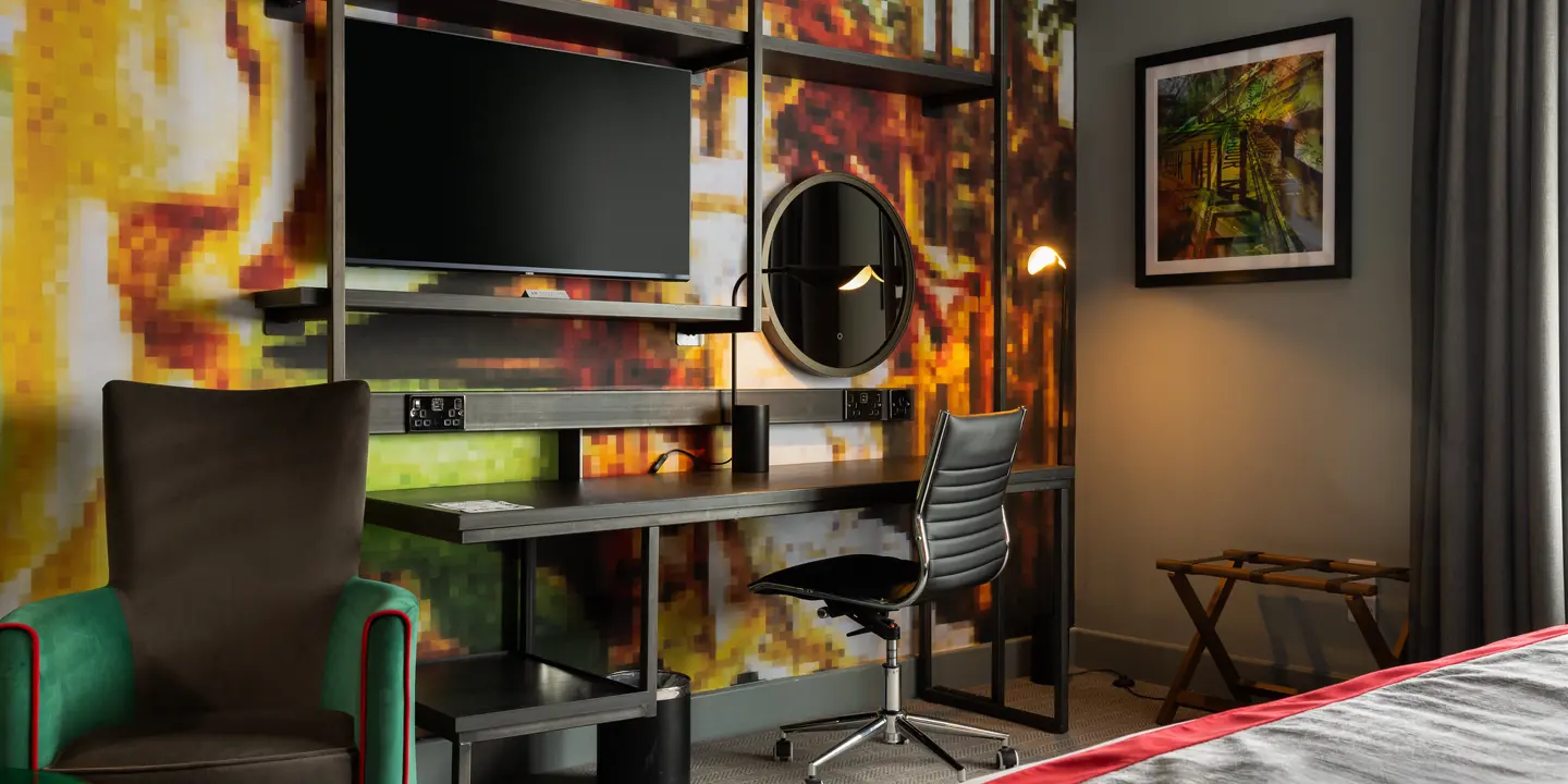 Spacious bedroom featuring desk and chair