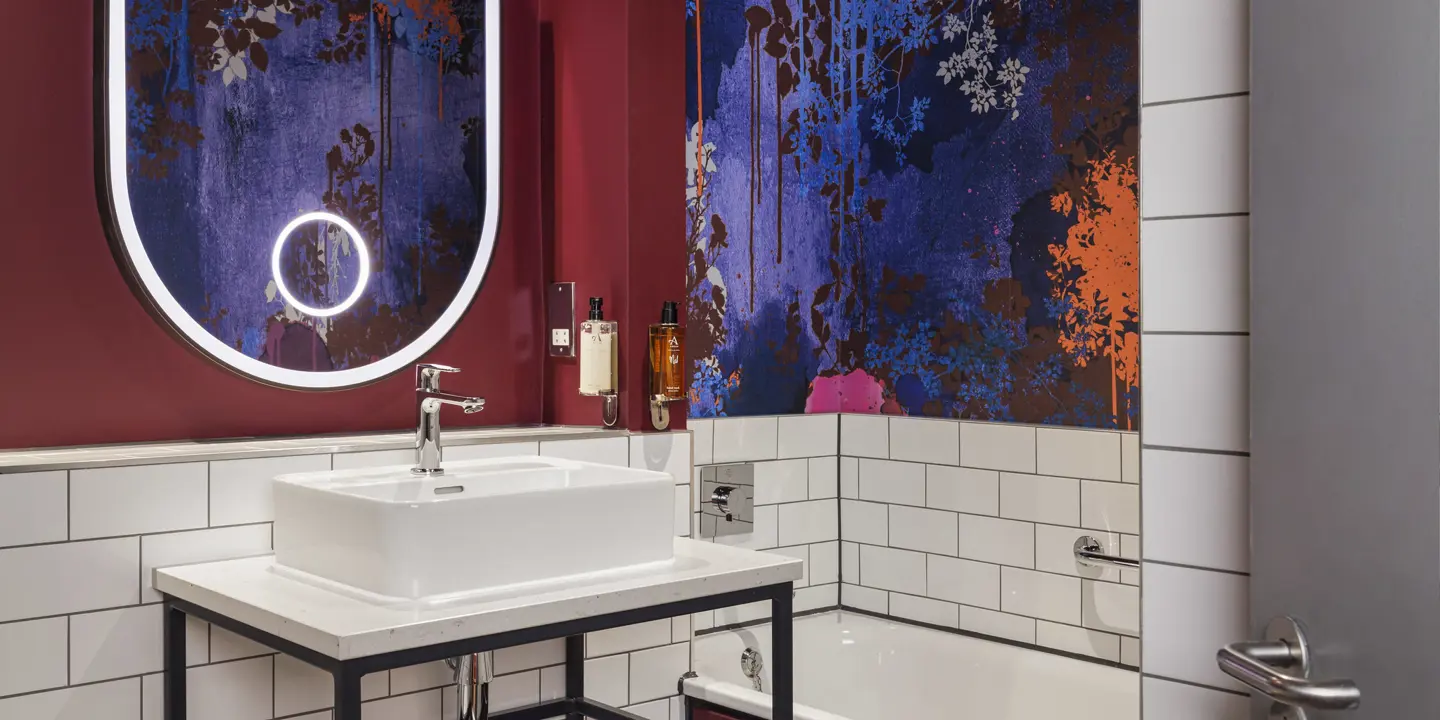 A bathroom featuring a sink, bathtub, and shower.