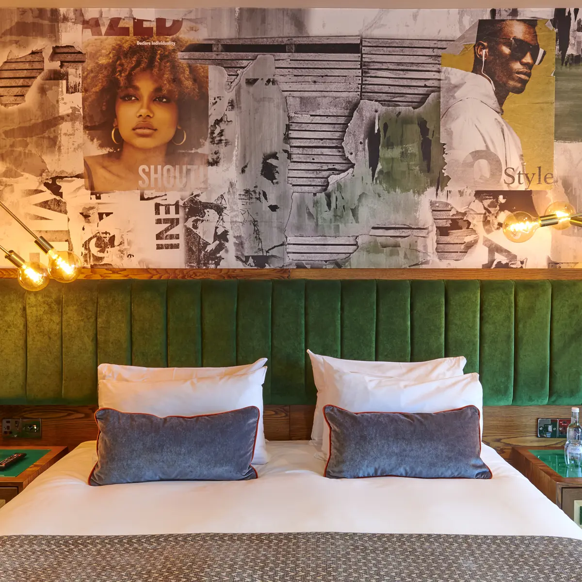 A well-furnished bedroom featuring a comfortable bed and two stylish lamps.