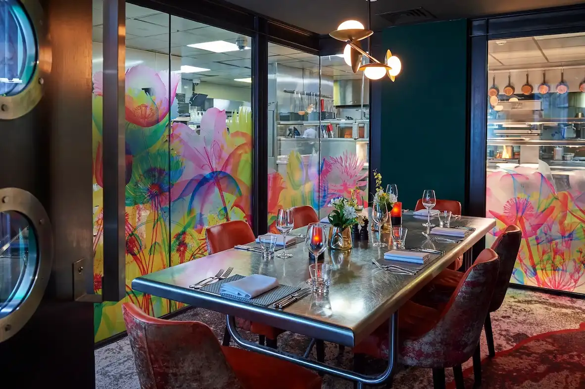 A table adorned with wine glasses and neatly arranged place settings.
