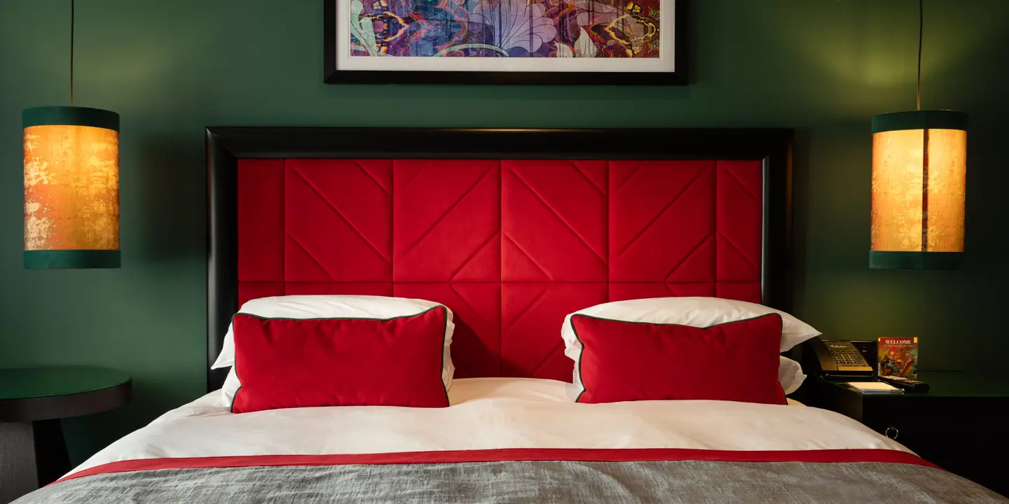 An elegantly furnished hotel room with large bed and comfy pillows