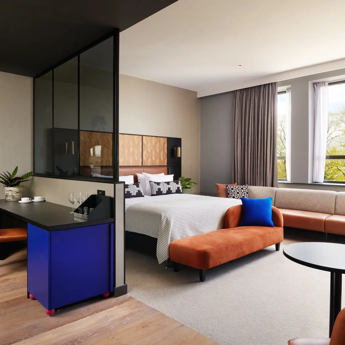 An elegant bed positioned in a serene bedroom beside a large window.