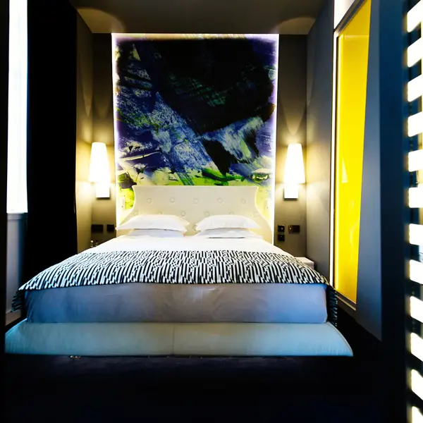 Spacious bedroom featuring a prominent wall painting.